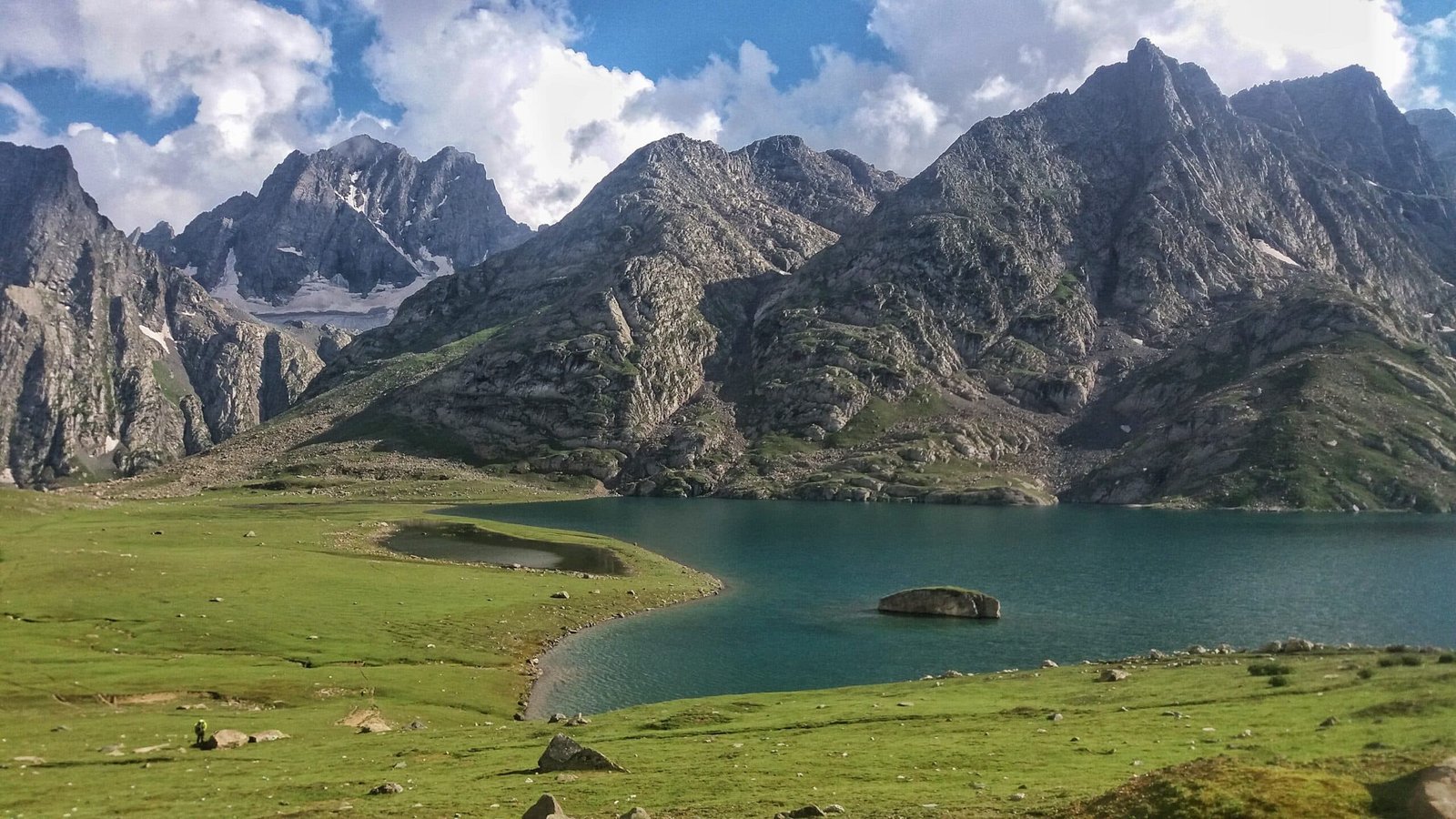 Kashmir Great Lakes with rocky peaks and green meadows