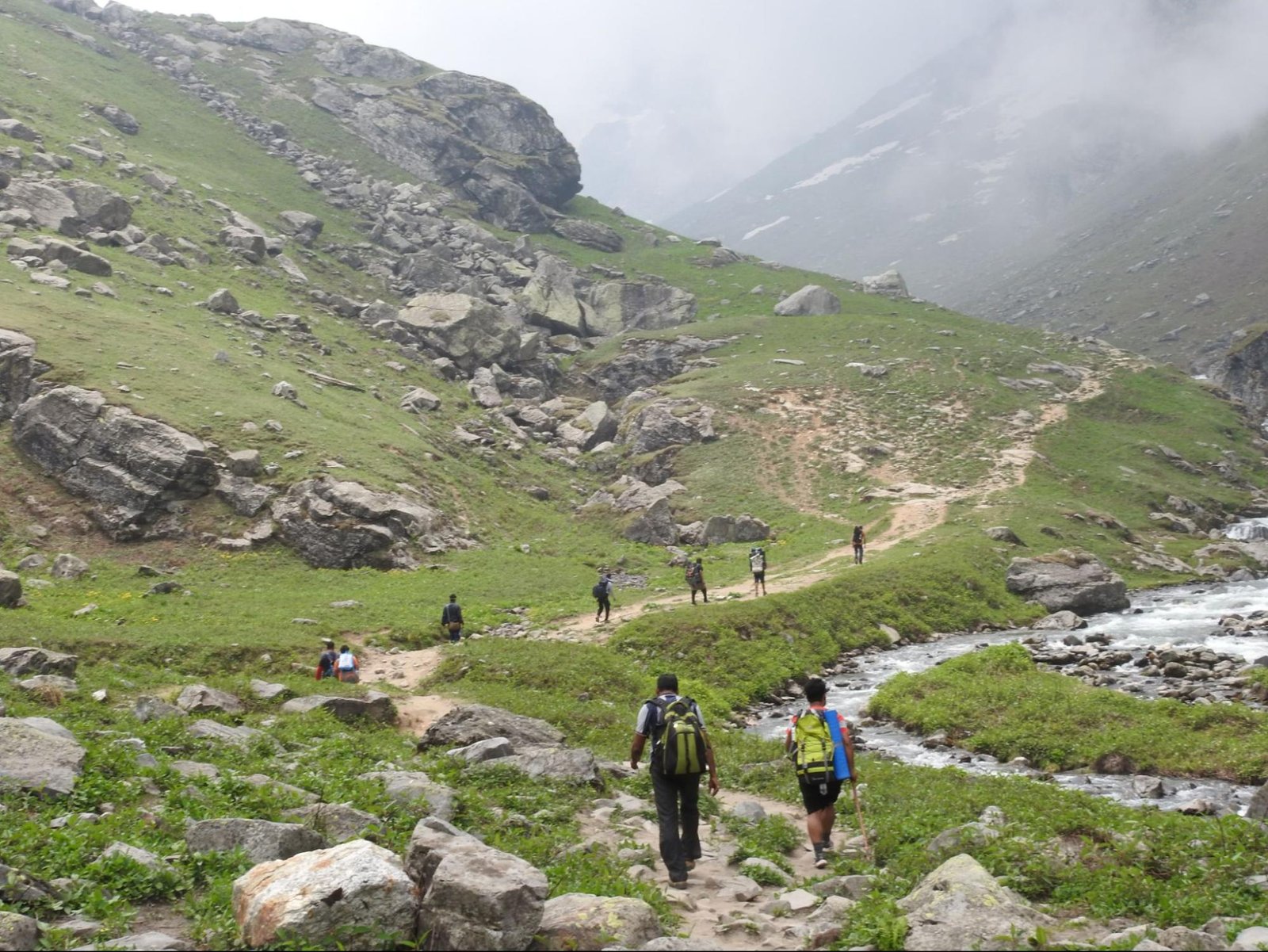 trekkers climbing the mountains at hampta pass trek
