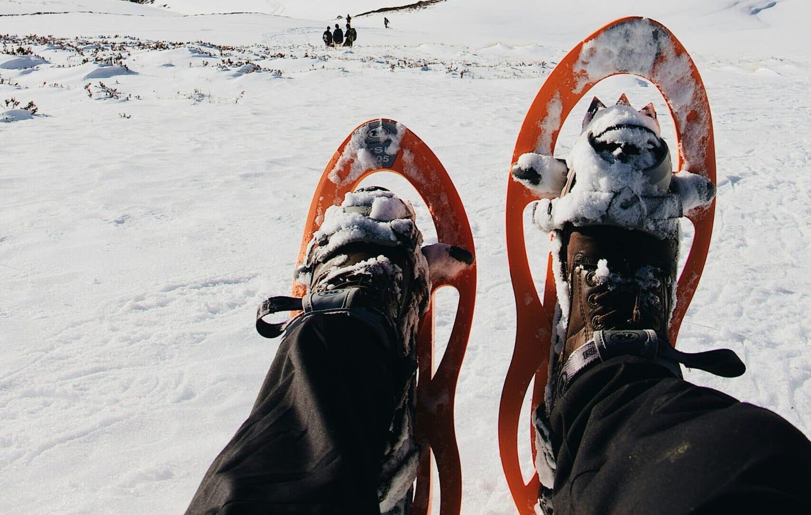 Person wearing snowshoes walking on snow in gulmarg