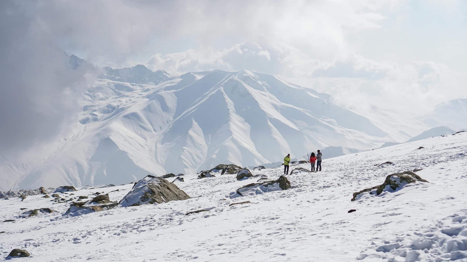 Tourists walking on a snow-covered mountain in kashmir