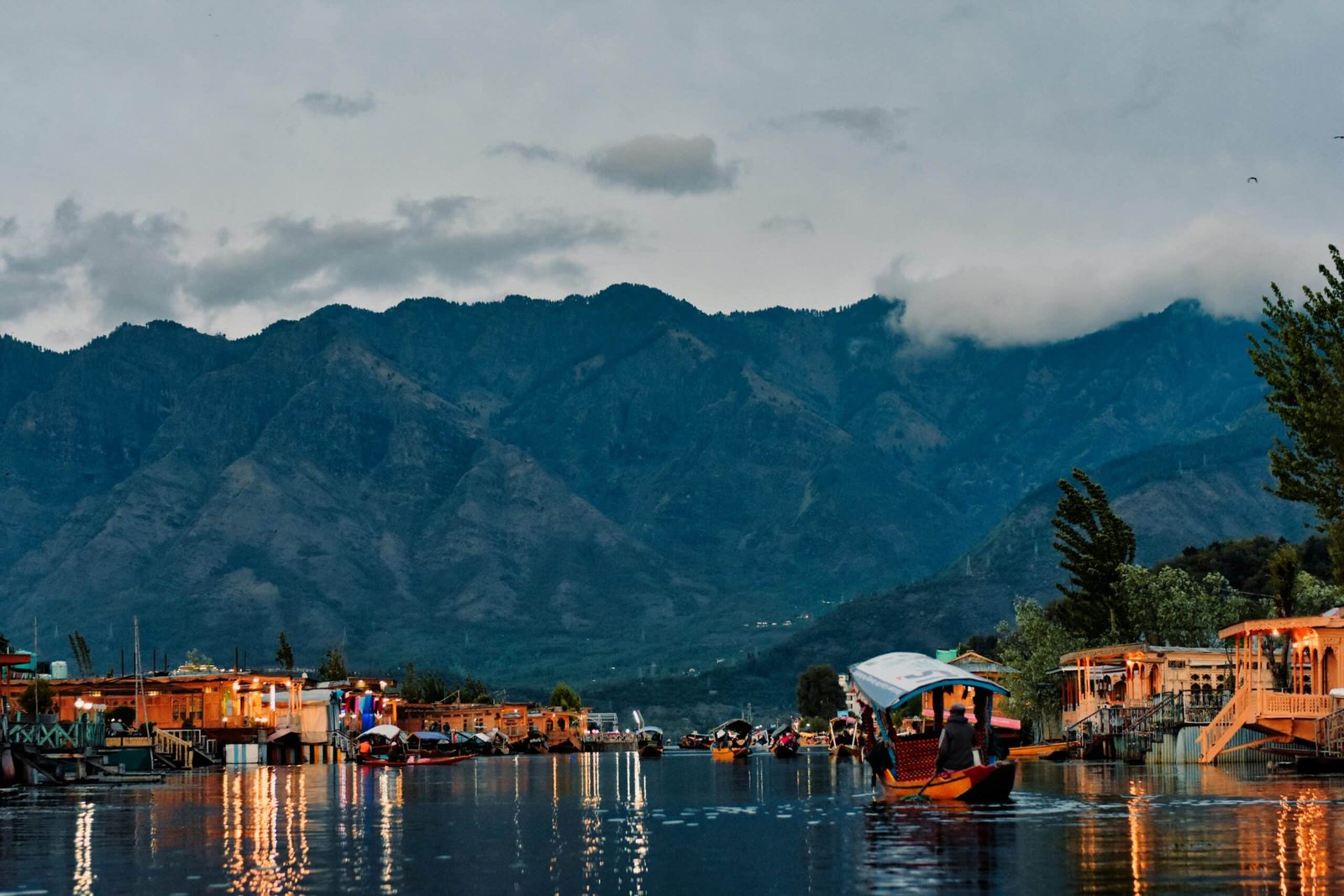 Shikara boats on Dal Lake with illuminated houseboats