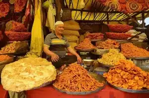 Man selling colorful traditional snacks in srinagar market