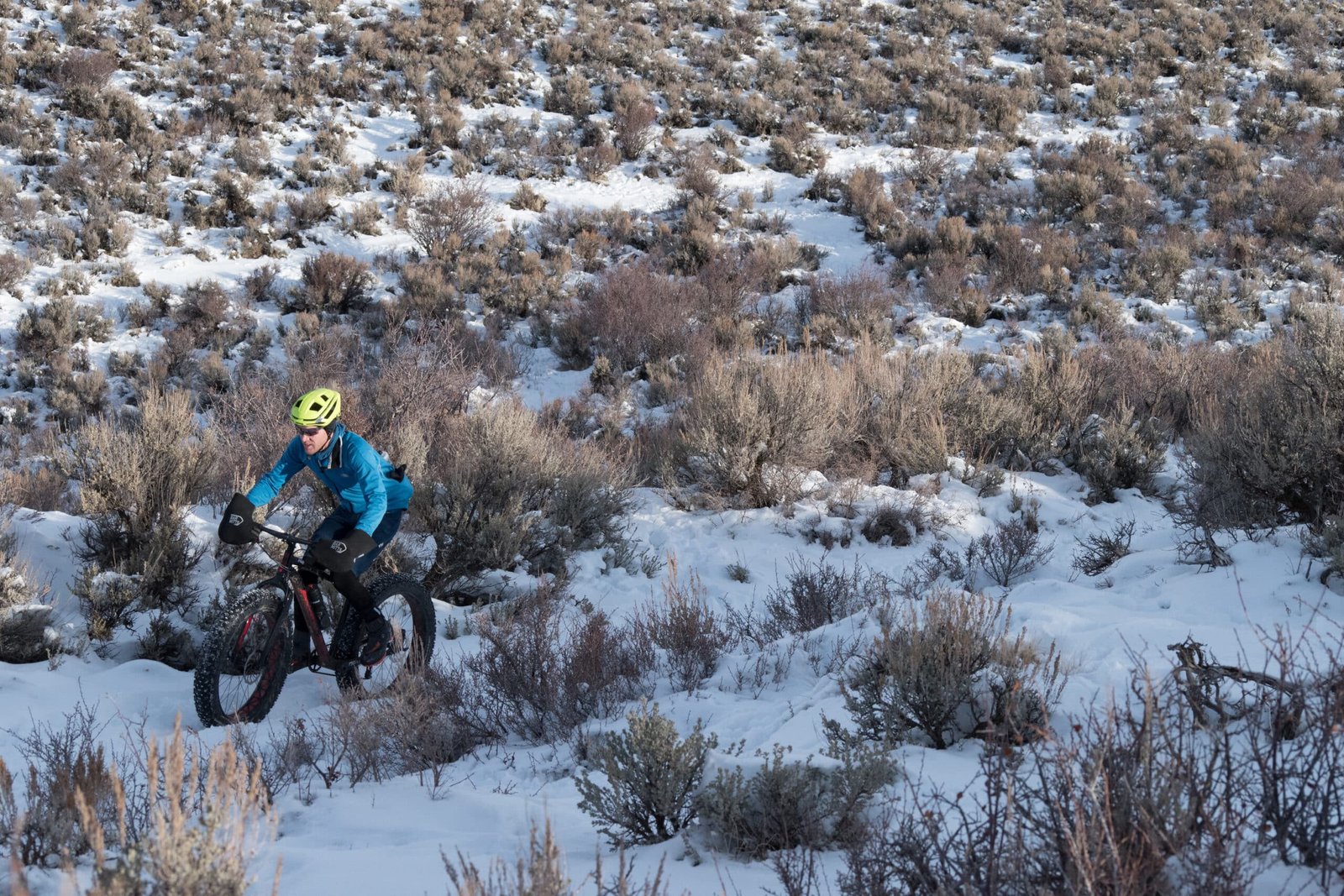 a biker riding through the snow covered trail of gulmarg