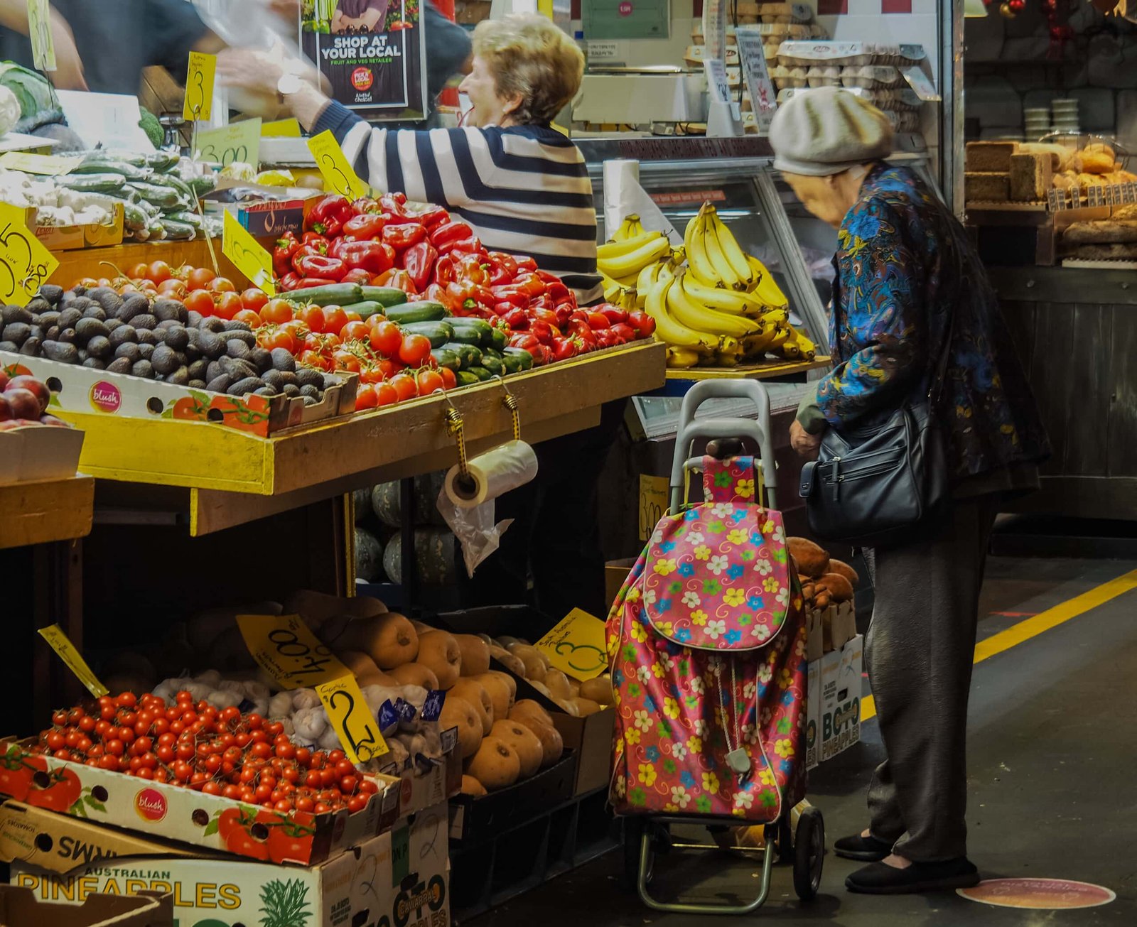 Women shopping for fresh fruits and vegetables at a market on Mall Road in Manali