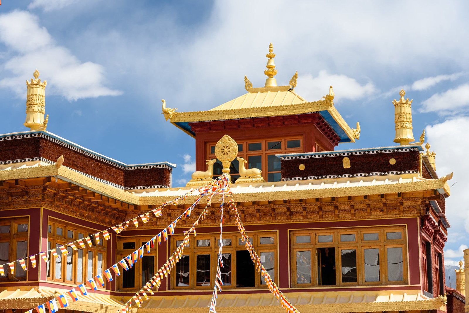 Matho Monastery with golden roof decorations and prayer flags