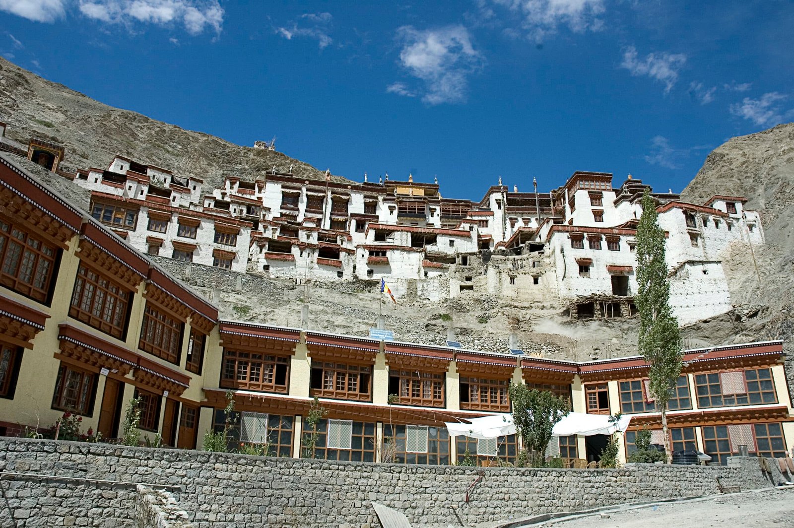 Rizong Monastery built on a rugged mountainside with whitewashed buildings and traditional wooden windows