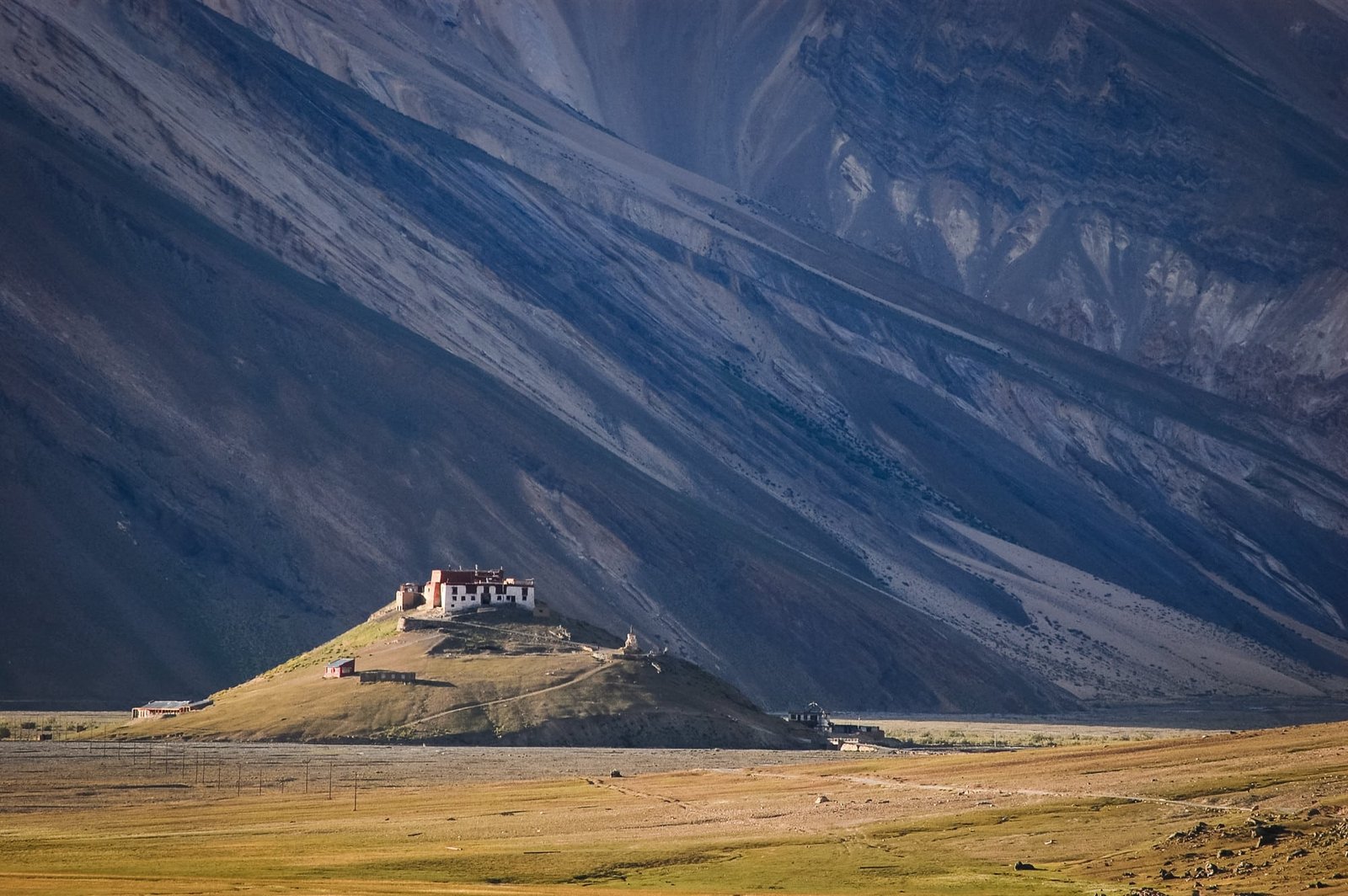 Rangdum Monastery on a small hill with vast mountains behind