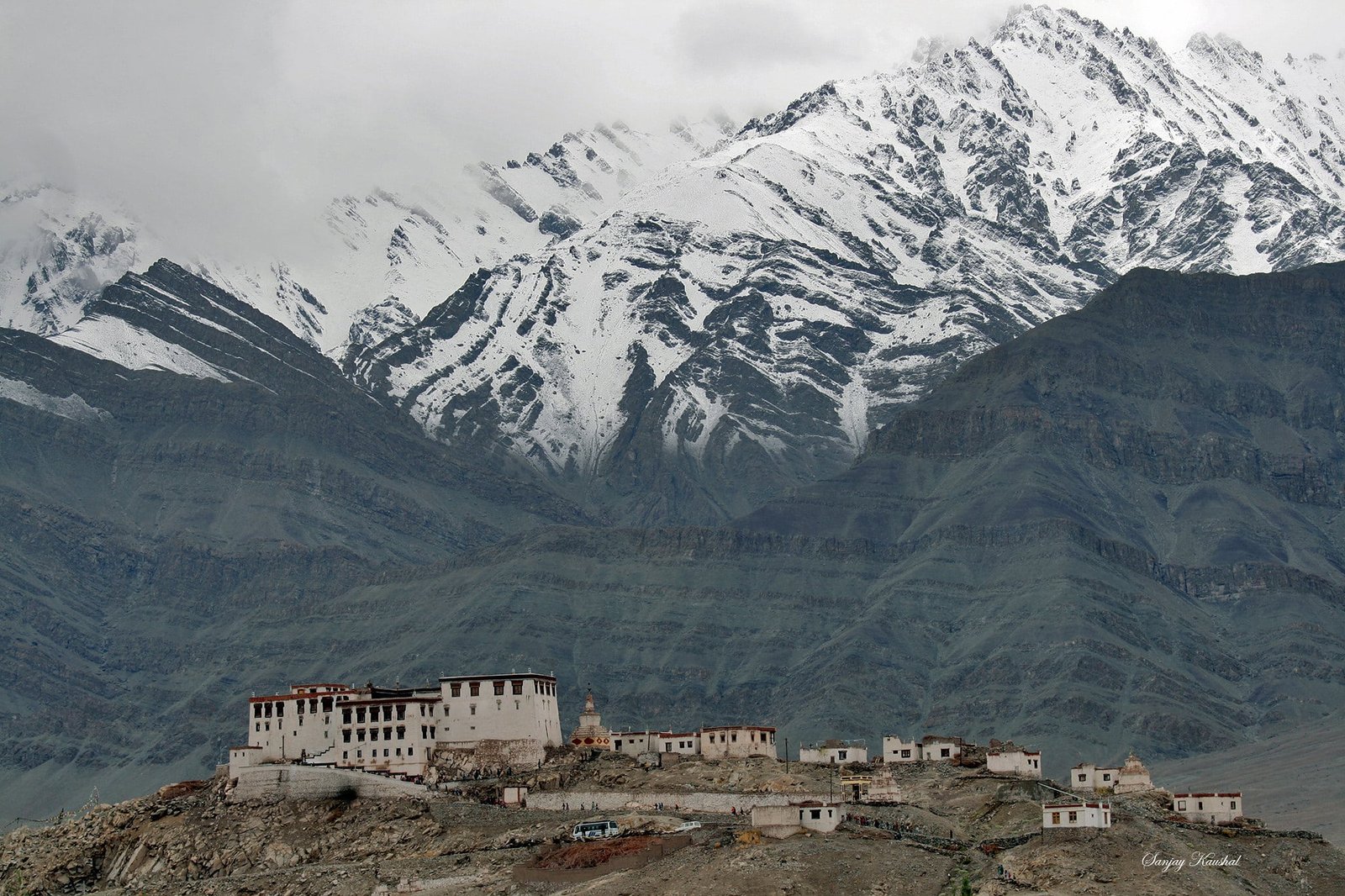 Stakna Monastery with snow-covered mountains in the background.