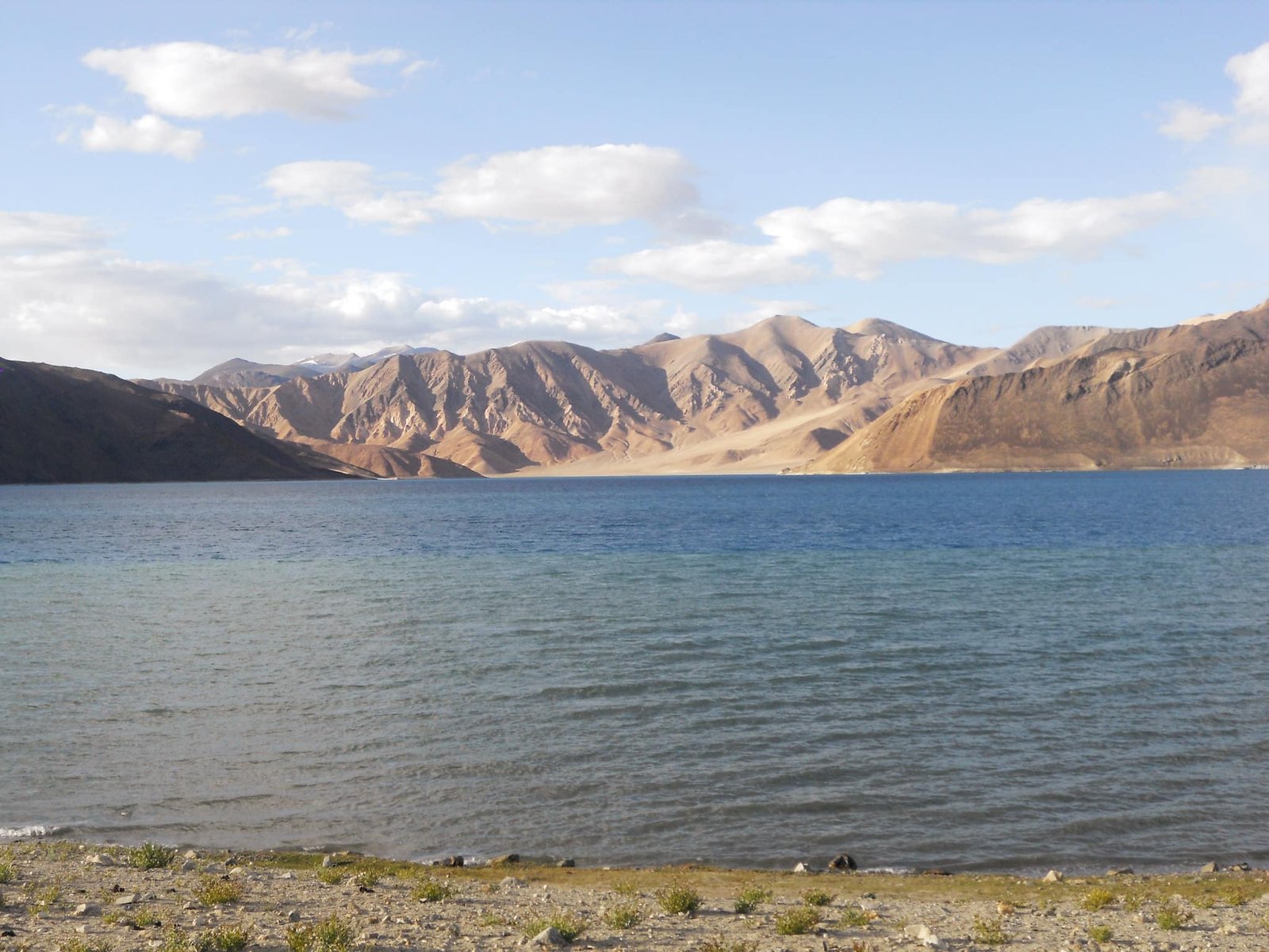 Clear view of Pangong Lake with calm blue water and barren mountains