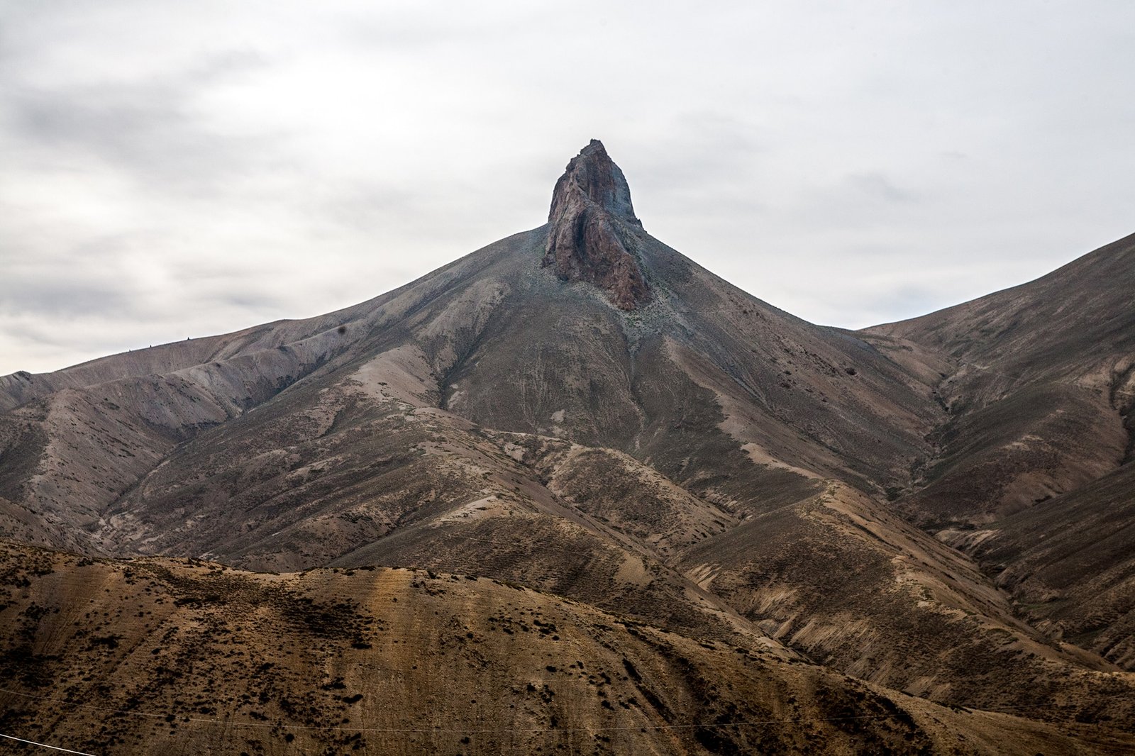 A pointed rocky peak on a barren mountain at Namika La Pass.
