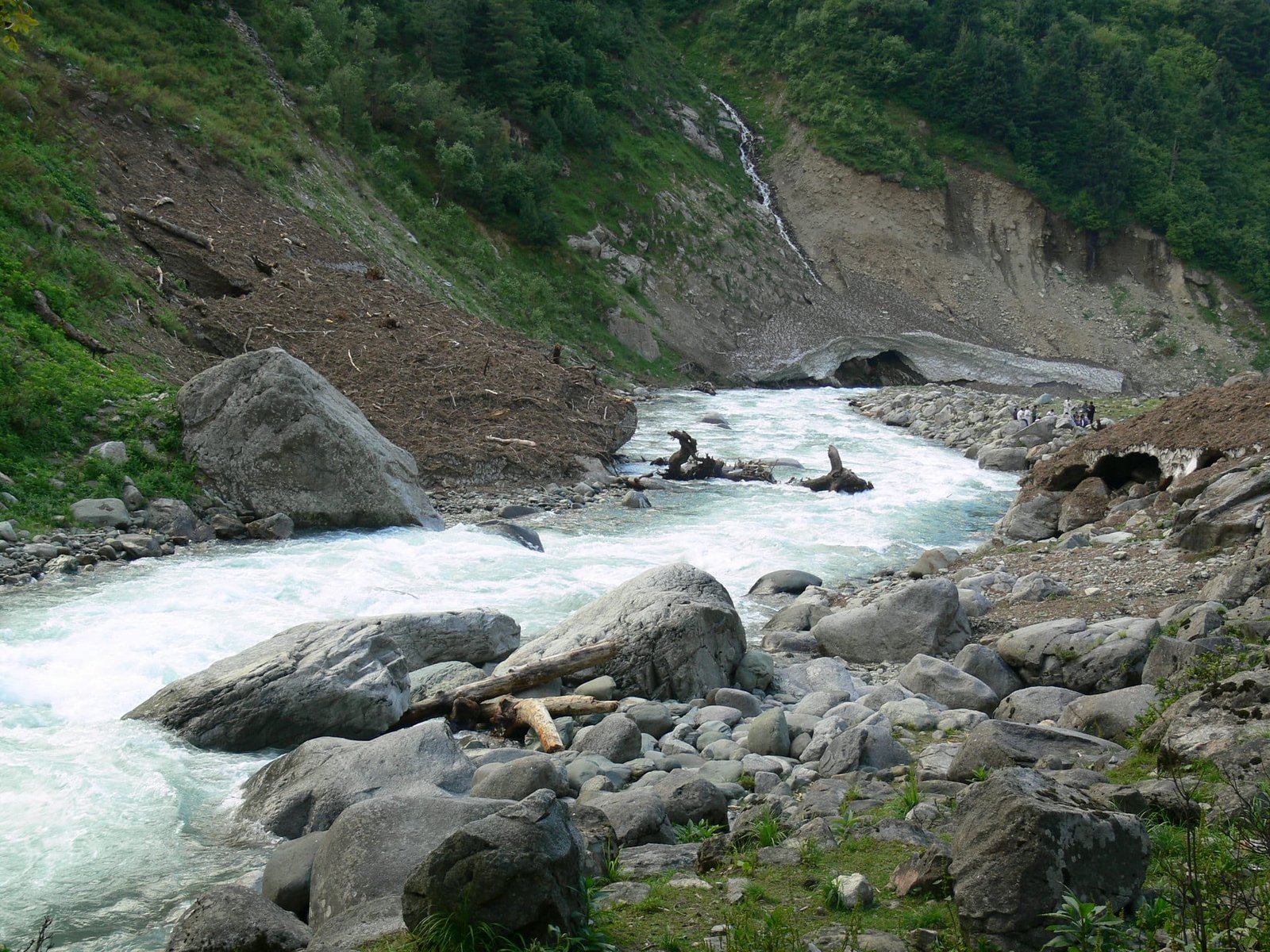 Mountain stream flowing through rocks and greenery in Naranag, Kashmir