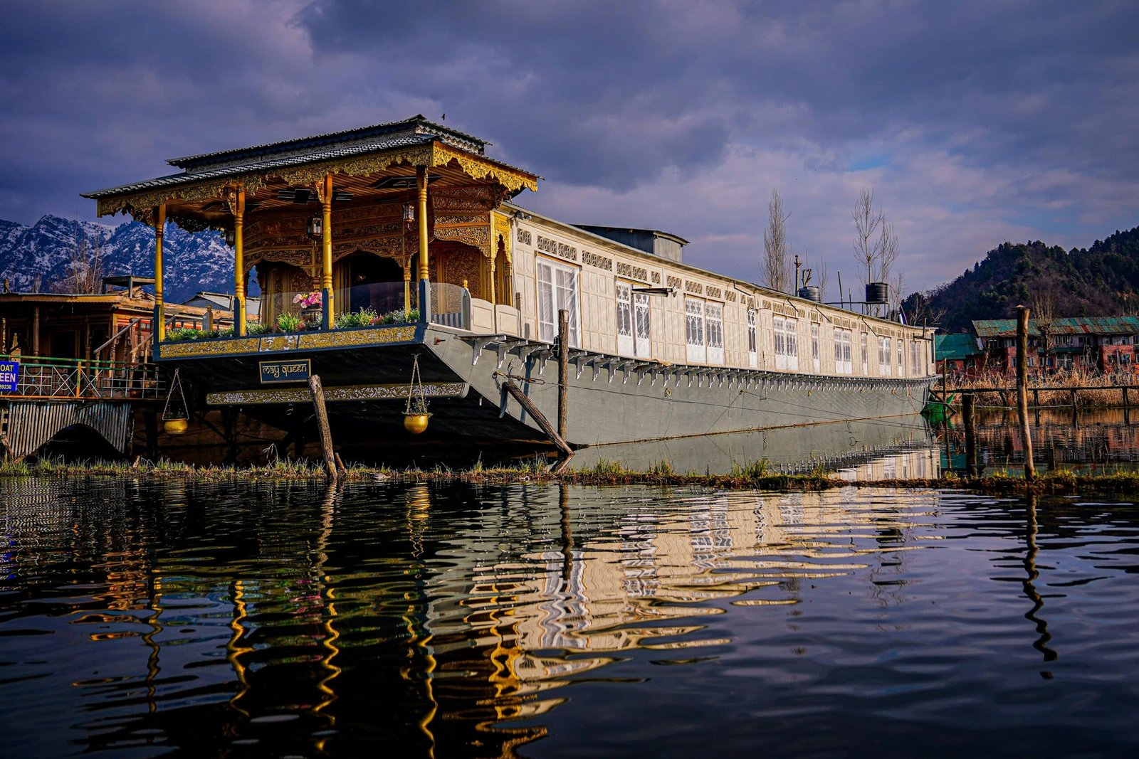 Traditional wooden houseboat floating on Dal Lake.