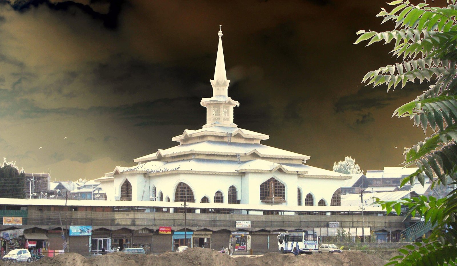 Charar-i-Sharief shrine with a white dome and tall spire under a dramatic sky