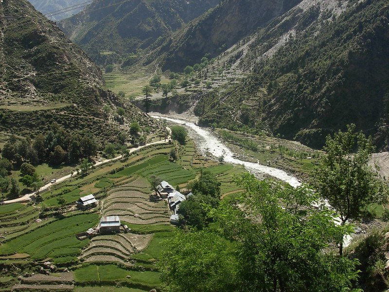 Terraced fields and small houses in Teetwal Valley with a river running through
