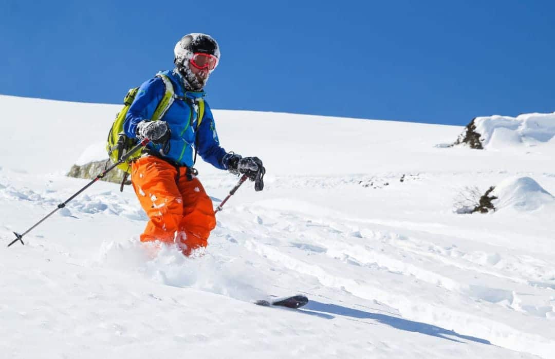 Snow skiing under bright blue Kashmir sky