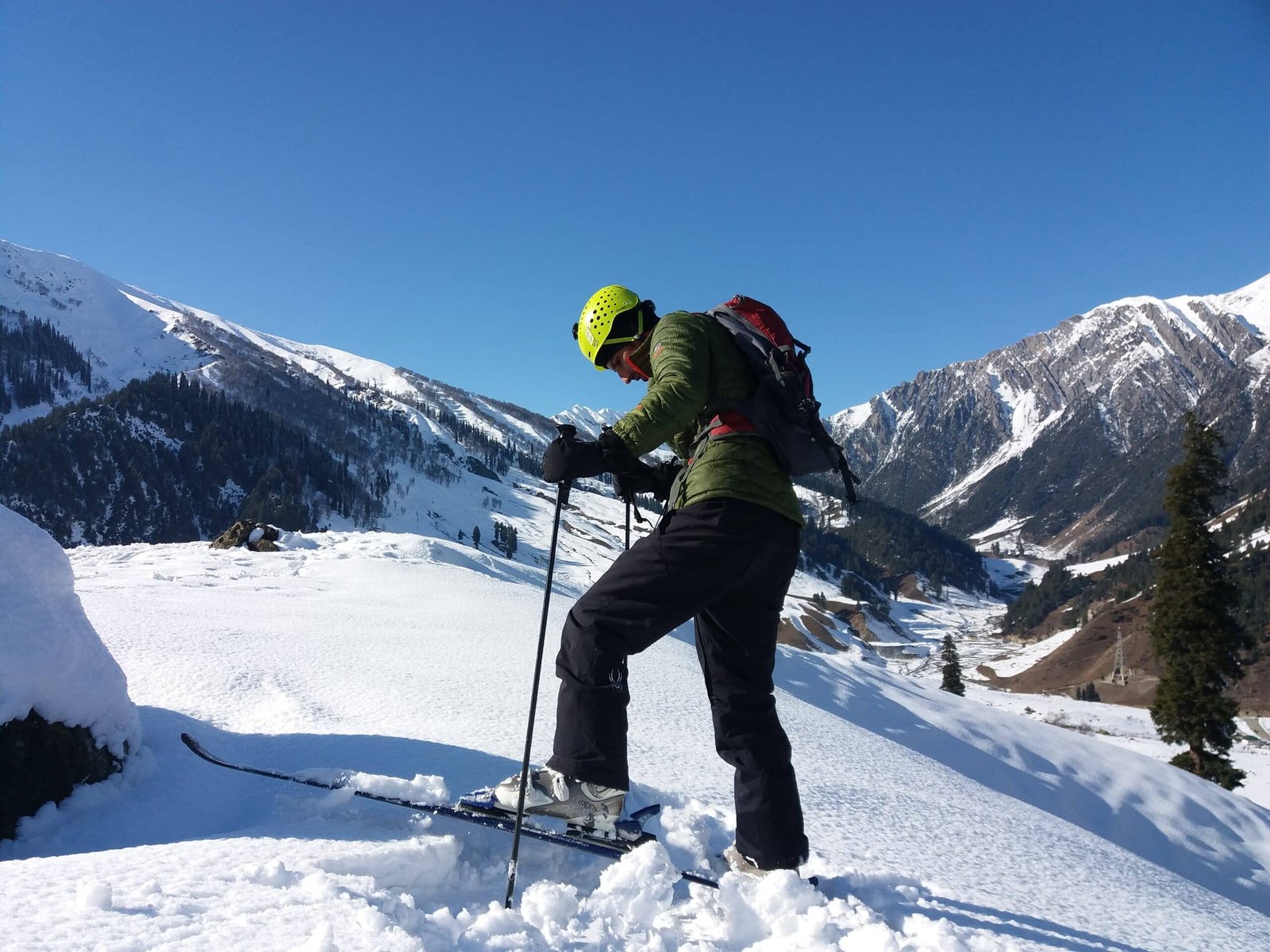 Skiing in Gulmarg in December with snow-covered mountains in the background