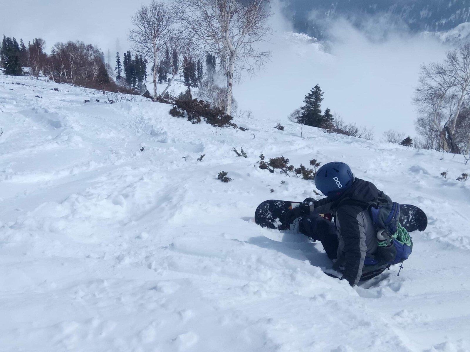 Snowboarder in deep snow at Gulmarg in February.