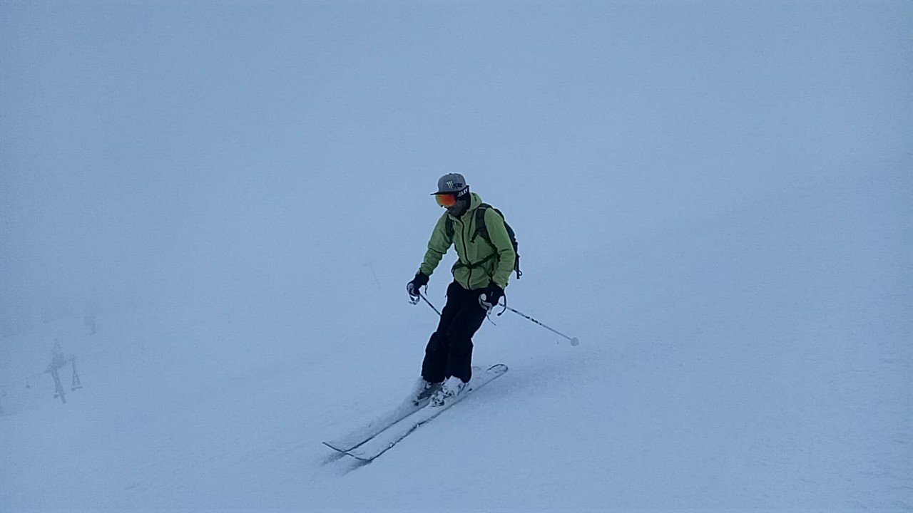 Skier gliding through fresh snow in Gulmarg during a foggy January day