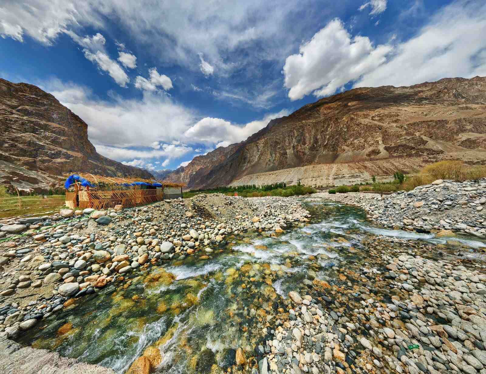 Scenic view of Turtuk village with a stream flowing through rocky terrain