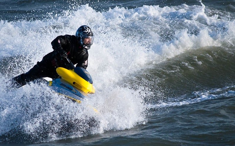 Person riding a jet ski on rough water