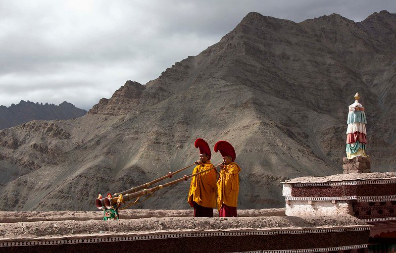 Monks playing long horns during Matho Nagrang Festival