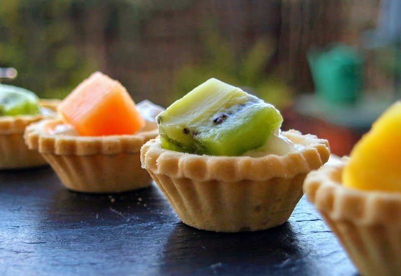 Mini fruit tart topped with a slice of kiwi
