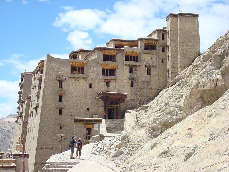 Leh Palace with visitors walking toward its entrance