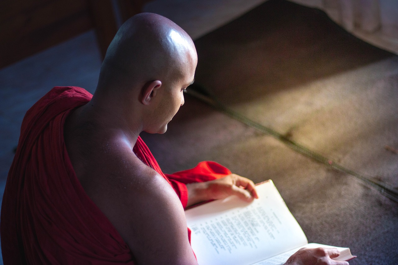 Buddhist monk reading a sacred text inside Turtuk Monastery