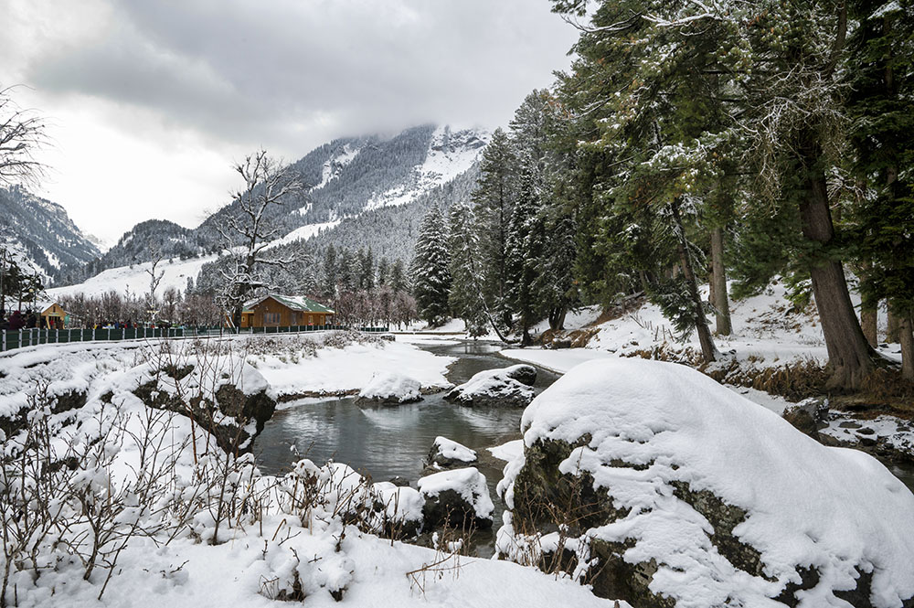Snow-covered landscape in Pahalgam during winter sightseeing