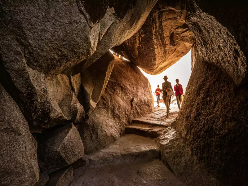 People exploring the inside of Kalaroos Caves in Kashmir