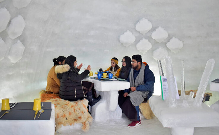 People dining inside an igloo café in Gulmarg
