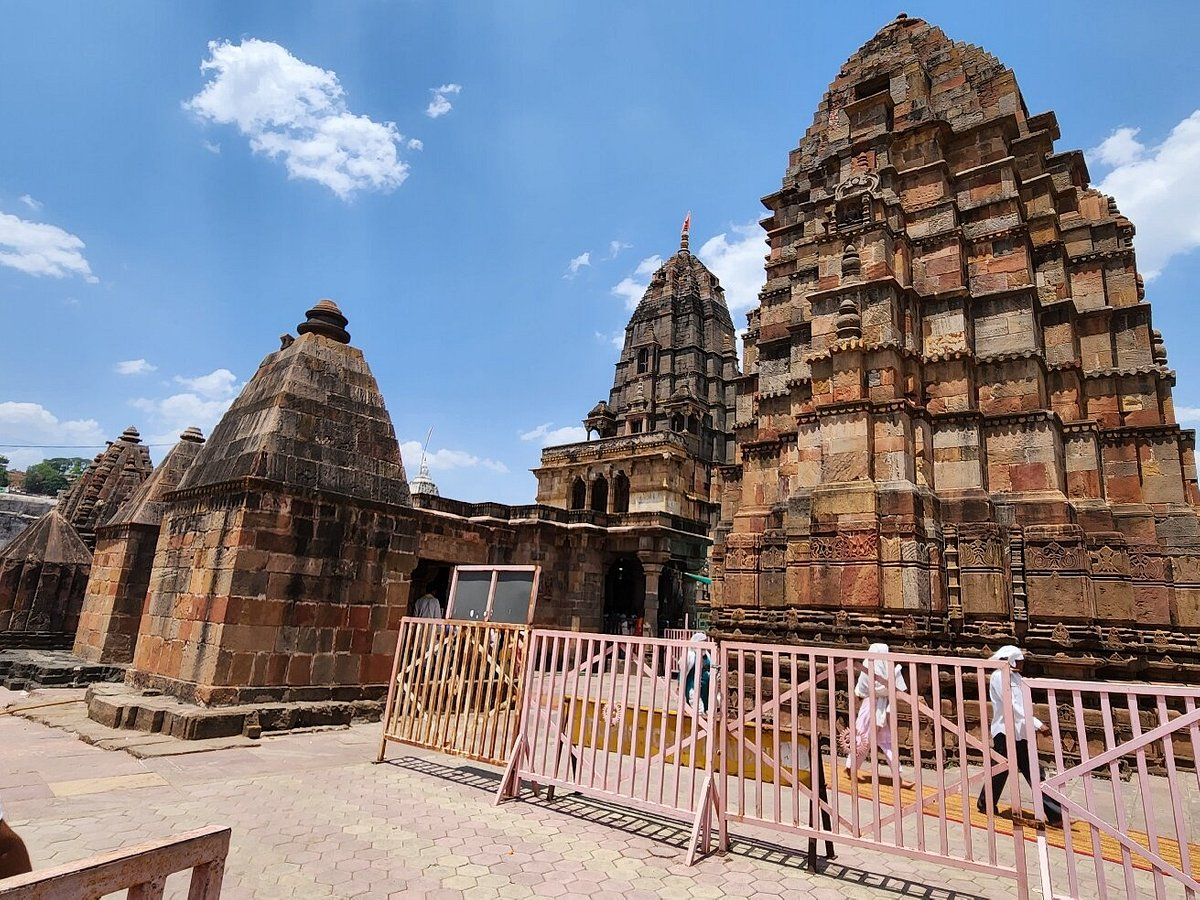 Ancient stone architecture of the Mamleshwar Temple in Pahalgam with visitors walking around the temple complex