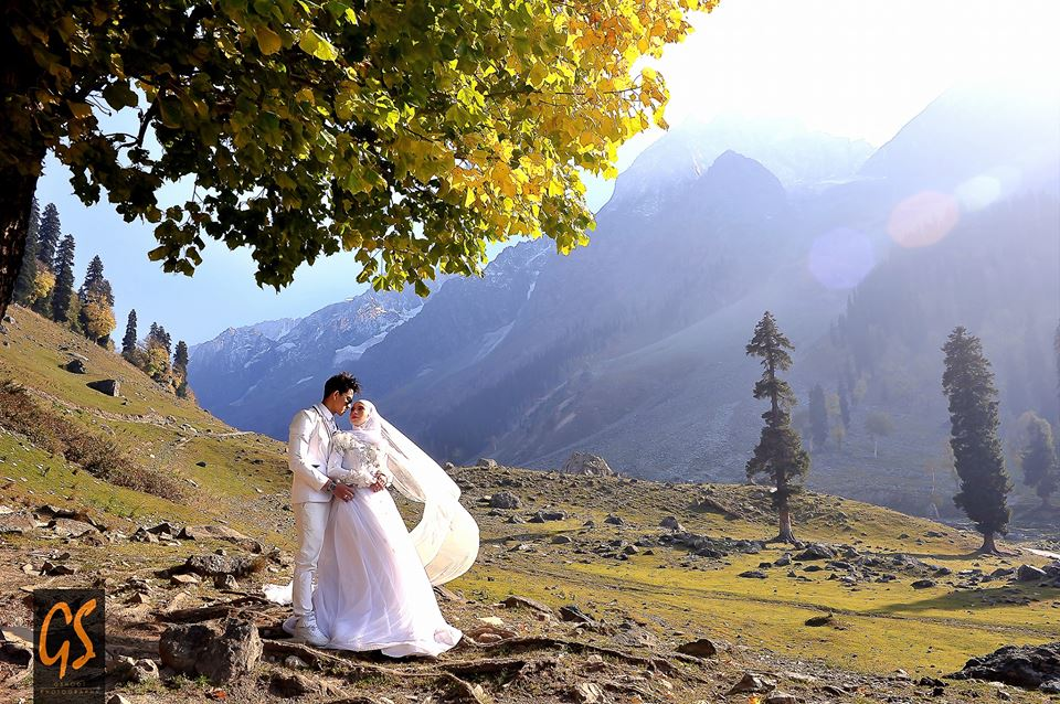 Couple posing for a photo in valley of kashmir