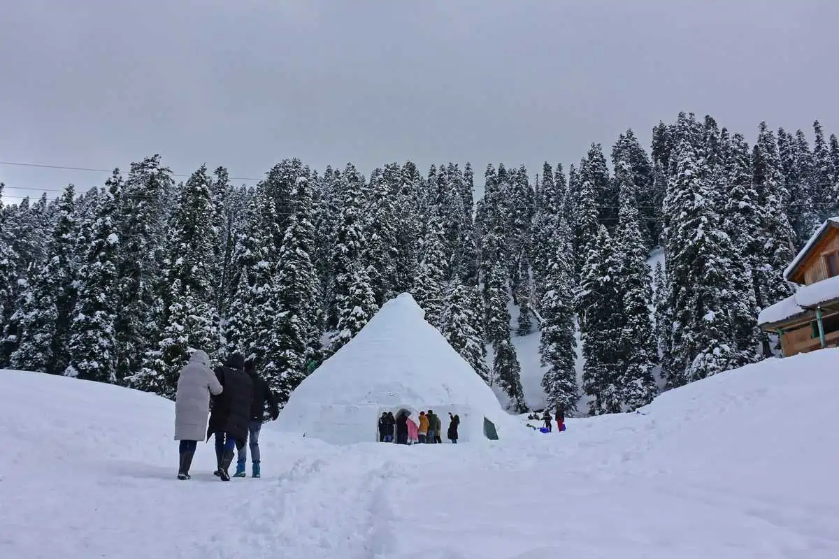 Visitors entering the Igloo Café in snowy Gulmarg during winter season